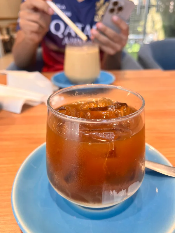 Iced coffee on a blue saucer